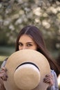 Pretty young woman in a summer garden, casual romantic style with hat Royalty Free Stock Photo