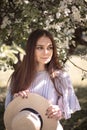 Pretty young woman in a summer garden, casual romantic style with hat Royalty Free Stock Photo