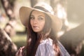 Pretty young woman in a summer garden, casual romantic style with hat Royalty Free Stock Photo