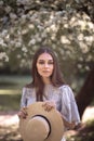 Pretty young woman in a summer garden, casual romantic style with hat Royalty Free Stock Photo