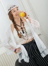 Pretty young woman with a summer hat drinks glass of orange juice Royalty Free Stock Photo