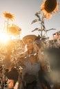 Pretty young woman in sunflowers field Royalty Free Stock Photo