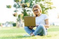 Pretty young woman surfing internet on laptop outdoors Royalty Free Stock Photo