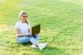 Pretty young woman surfing internet on laptop outdoors Royalty Free Stock Photo