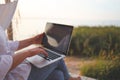 Pretty young woman surfing internet on laptop outdoors Royalty Free Stock Photo