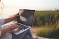 Pretty young woman surfing internet on laptop outdoors Royalty Free Stock Photo