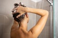 Pretty, young woman taking a long hot shower washing her hair Royalty Free Stock Photo