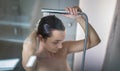 Pretty, young woman taking a long hot shower washing her hair Royalty Free Stock Photo