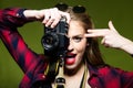 Pretty young woman taking photos with a retro camera. Royalty Free Stock Photo