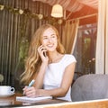 Pretty young woman talking by phone. Happy female person outdoors. Summer Royalty Free Stock Photo