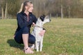 Pretty young woman teaching her dog commands