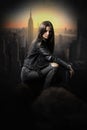 Pretty young woman thief over the rooftops wearing a black leather jaket. Royalty Free Stock Photo