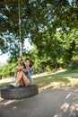 Pretty young woman in tire swing Royalty Free Stock Photo