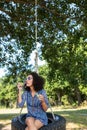 Pretty young woman in tire swing Royalty Free Stock Photo