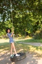 Pretty young woman in tire swing Royalty Free Stock Photo