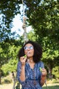 Pretty young woman in tire swing Royalty Free Stock Photo