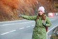 Woman tourist hitch-hiking on the road Royalty Free Stock Photo
