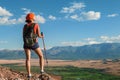 Pretty young woman tourist standing on top of mountain Royalty Free Stock Photo