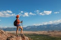 Pretty young woman tourist standing on top of mountain Royalty Free Stock Photo