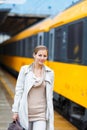 Pretty young woman at a train station Royalty Free Stock Photo