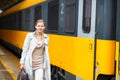 Pretty young woman at a train station Royalty Free Stock Photo