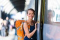 Pretty, young woman in a trainstation, waiting for her train Royalty Free Stock Photo