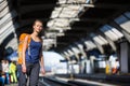 Pretty, young woman in a trainstation, waiting for her train Royalty Free Stock Photo