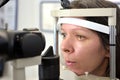 Pretty young woman undergone an ocular fundus inspection with ophthalmologist optometrist optician