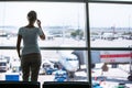 Pretty, young woman waiting at a gate area of a modern airport Royalty Free Stock Photo