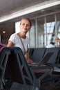 Pretty, young woman waiting at a gate area of a modern airport Royalty Free Stock Photo