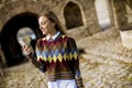 Pretty young woman walking in autumn park and using a mobile phone Royalty Free Stock Photo