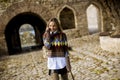 Pretty young woman walking in autumn park and using a mobile phone Royalty Free Stock Photo