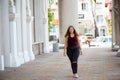 Pretty young woman walking on the city street. Casual fashion, plus size model. xxl women on nature. Royalty Free Stock Photo