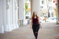 Pretty young woman walking on the city street. Casual fashion, plus size model. xxl women on nature. Royalty Free Stock Photo