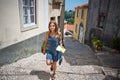 A pretty young woman walking on a street in Lisbon Royalty Free Stock Photo