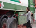 Woman washing truck with high pressure water jet