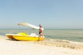 Pretty young woman wearing black swimsuit and sunglasses posing on the catamaran Royalty Free Stock Photo