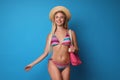 Pretty young woman wearing stylish bikini with bag Royalty Free Stock Photo