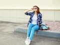 Pretty young woman wearing a sunglasses summer straw hat and checkered shirt with backpack Royalty Free Stock Photo