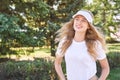 Pretty young woman wearing tennis hat. White t-shirt. Female sport player Royalty Free Stock Photo