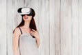 A pretty young woman wearing virtual reality glasses, excitedly Royalty Free Stock Photo