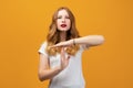 Pretty Young woman Doing time-out gesture with hands, frustrated and serious face. Studio shot, yellow background Royalty Free Stock Photo