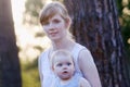 Pretty young woman in white and her little cute daughter