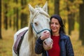 A pretty young woman and a white horse are beautiful couple Royalty Free Stock Photo