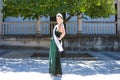 Pretty young woman winner of a beauty pageant dressed in a green sequined dress.