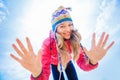 Pretty young woman in winter day dressed in woolen hat showing o Royalty Free Stock Photo