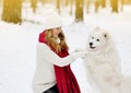 Pretty Young Woman in Winter Forest Park Walking with her Dog White Samoyed Royalty Free Stock Photo