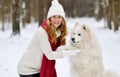 Pretty Young Woman in Winter Forest Walking with her Dog White Samoyed Royalty Free Stock Photo
