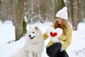 Pretty Young Woman in Winter Snowy Forest Park Walking with her Dog Royalty Free Stock Photo