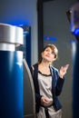 Pretty, young woman withdrawing money from her credit card